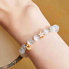 Fortune Jewel 925 Sterling Silver Peach Blossom Lucky Bag White Cat's Eye Luck Bracelet