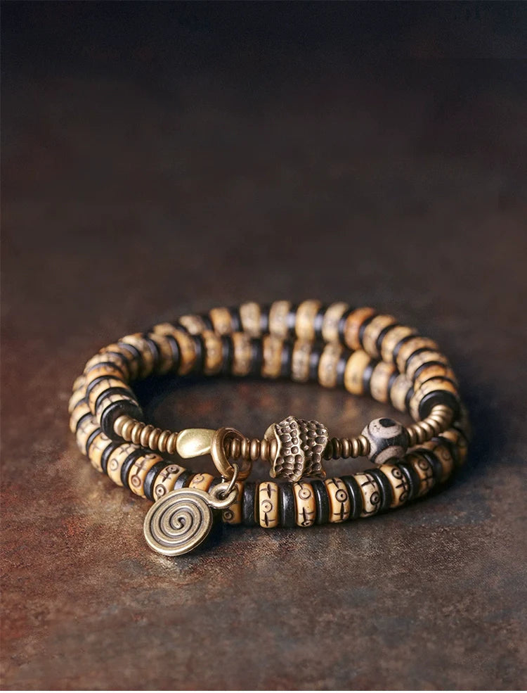 Double-Wrap Tibetan-Style Hand-Carved Bone Bead Bracelet with Ebony Spacers, Brass Accents, and Agate Dzi Charm