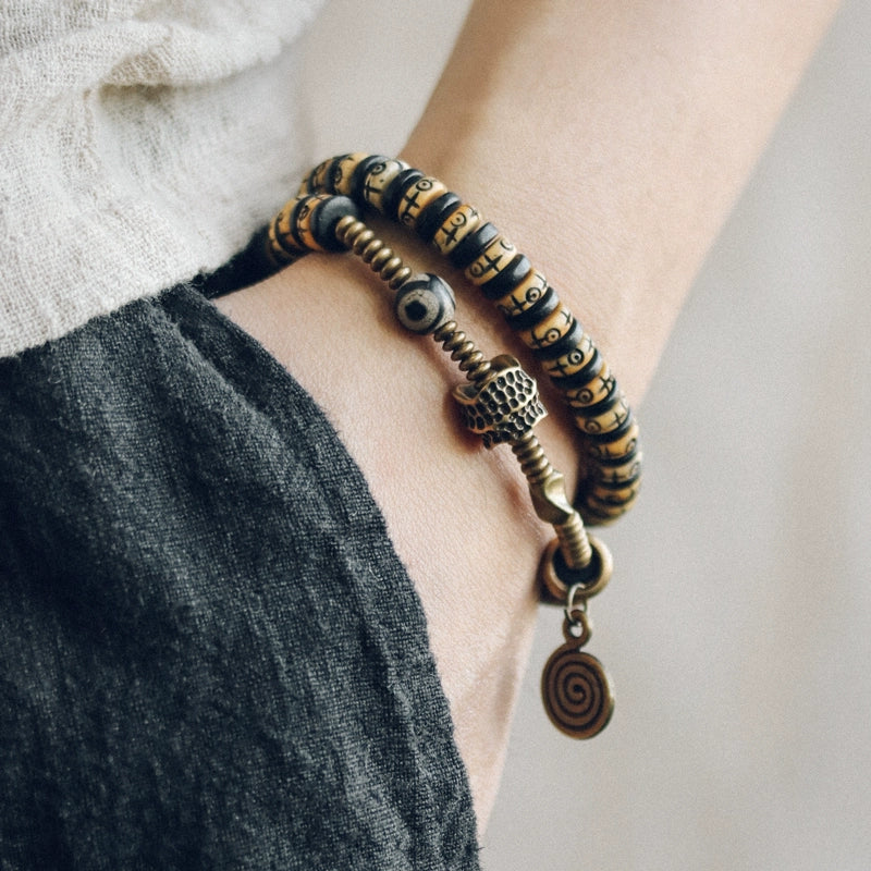 Double-Wrap Tibetan-Style Hand-Carved Bone Bead Bracelet with Ebony Spacers, Brass Accents, and Agate Dzi Charm