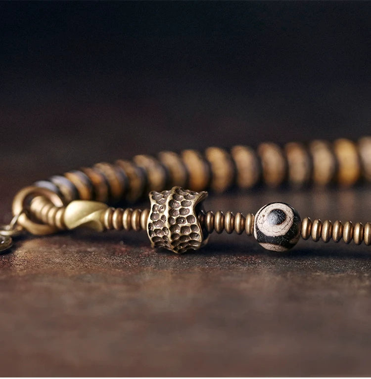 Double-Wrap Tibetan-Style Hand-Carved Bone Bead Bracelet with Ebony Spacers, Brass Accents, and Agate Dzi Charm