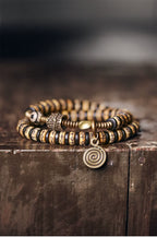 Double-Wrap Tibetan-Style Hand-Carved Bone Bead Bracelet with Ebony Spacers, Brass Accents, and Agate Dzi Charm